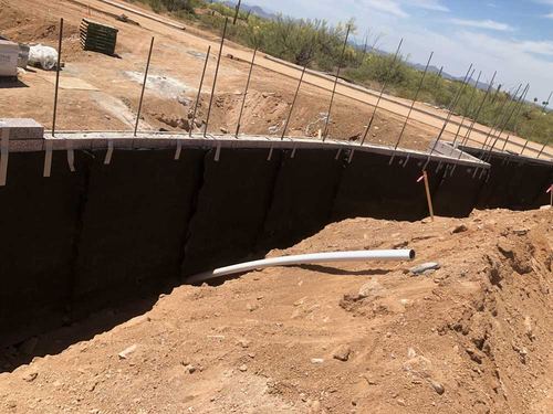 Below-grade waterproofing membrane on a block foundation wall